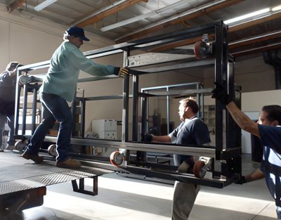 The CBC crew unloads the first large section of wall frame